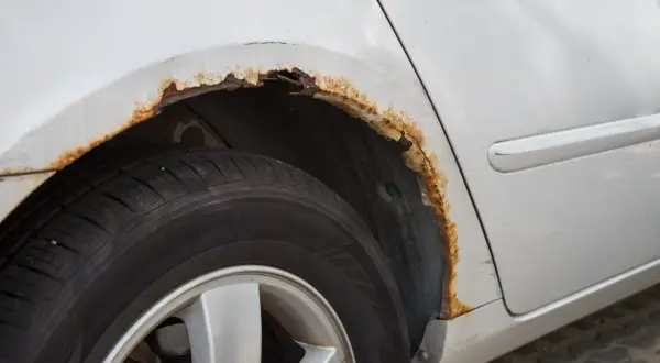 Rost am Auto: Ein Radkasten zeigt deutliche Spuren von Korrosion. Hier sieht man, wie entsteht rost am auto durch Feuchtigkeit und Salz.
