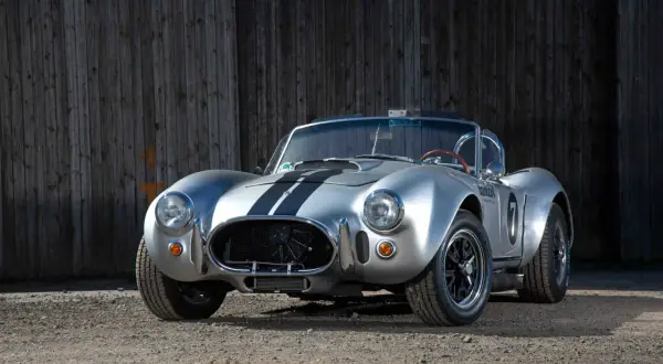 Silberner Cobra Shelby mit schwarzen Streifen, bereit für die Rennstrecke.